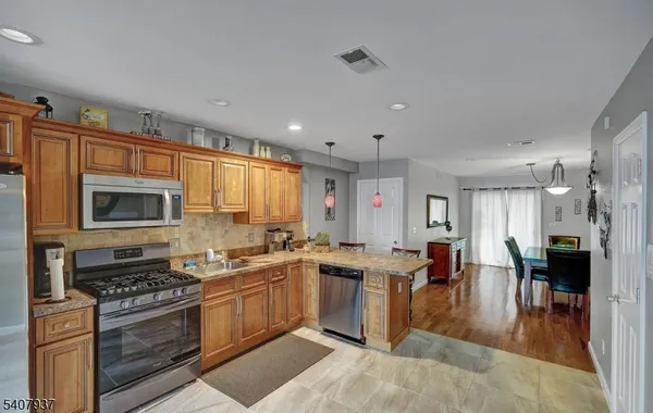 a kitchen with lots of counter top space and stainless steel appliances