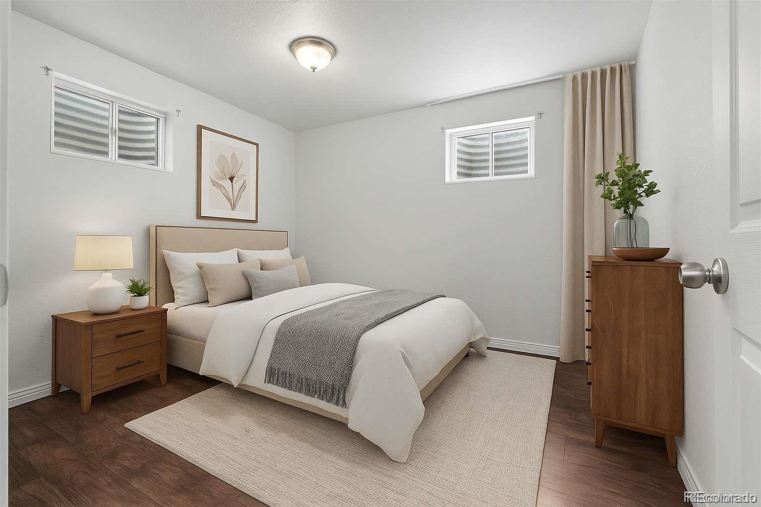 5167 Sable Street Denver, CO 80239 - Photo 14 of 27 a bedroom with a bed and a potted plant