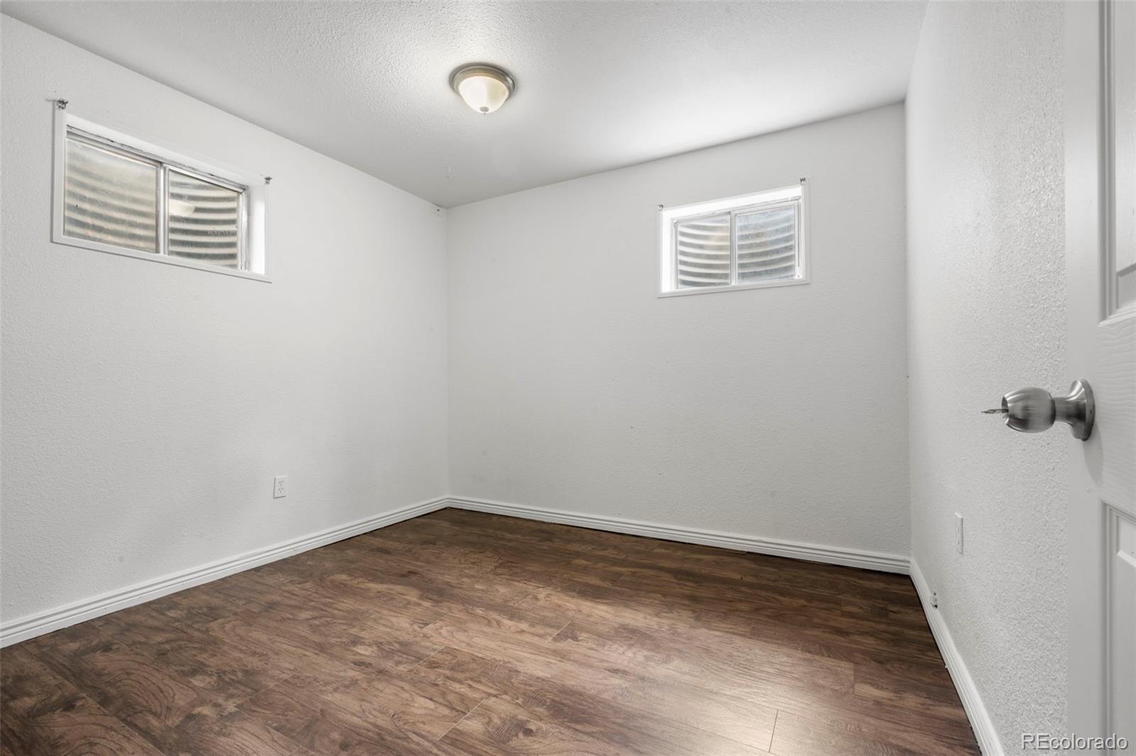 5167 Sable Street Denver, CO 80239 - Photo 15 of 27 wooden floor in an empty room