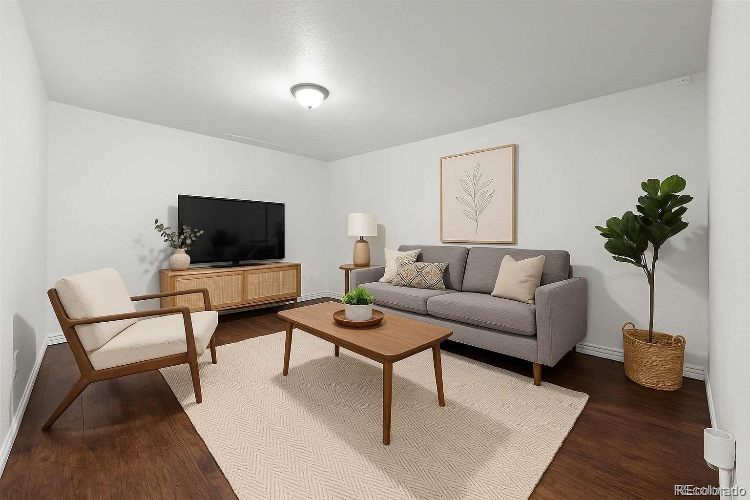5167 Sable Street Denver, CO 80239 - Photo 20 of 27 a living room with furniture and a flat screen tv