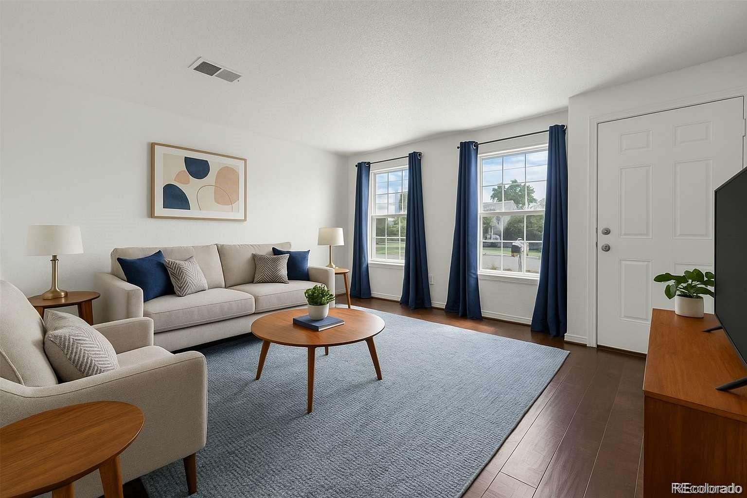 5167 Sable Street Denver, CO 80239 - Photo 5 of 27 a living room with furniture and wooden floor