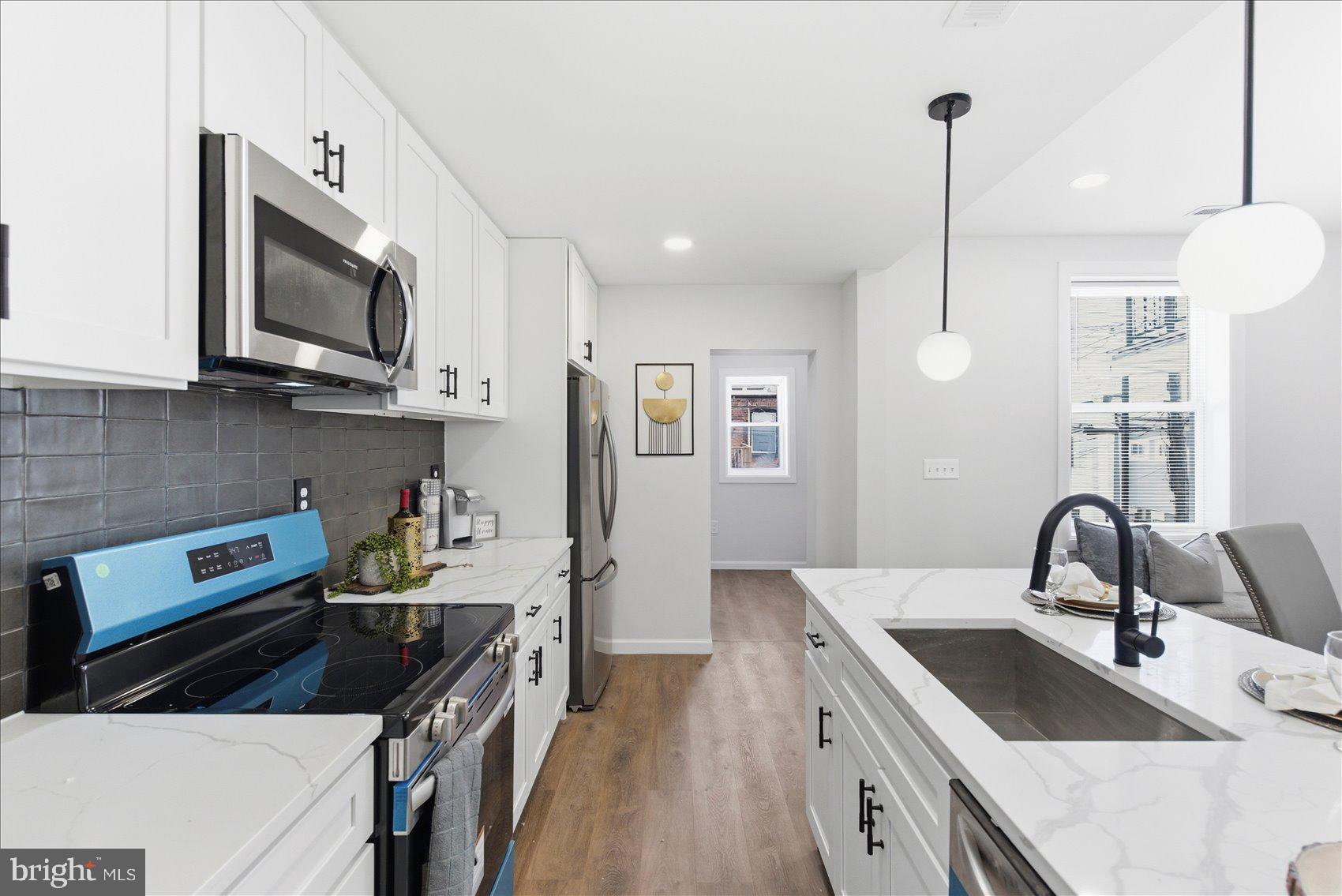 2009 Ruxton Avenue Baltimore, MD 21216 - Photo 11 of 37 a kitchen with granite countertop a sink stainless steel appliances and cabinets