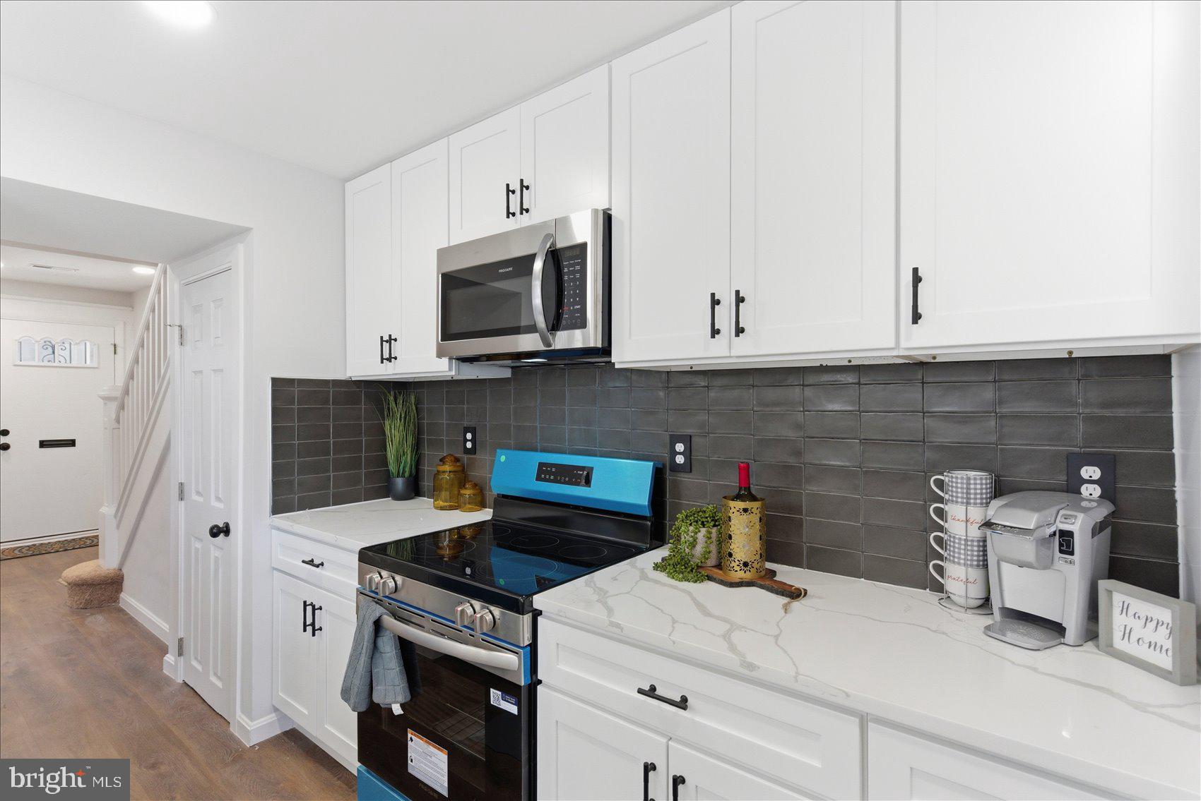 2009 Ruxton Avenue Baltimore, MD 21216 - Photo 12 of 37 a kitchen with stainless steel appliances white cabinets and a stove a oven with white countertops