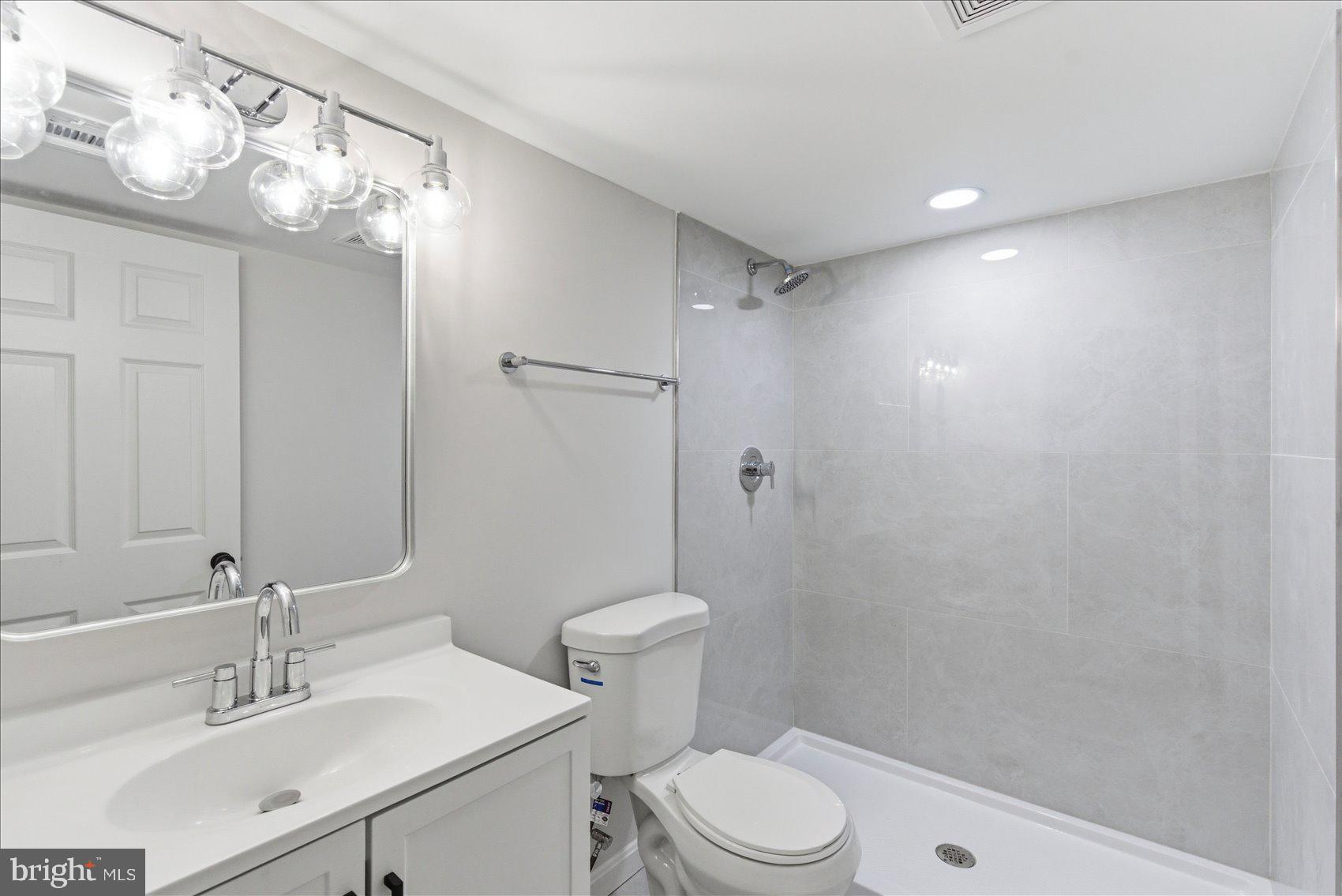 2009 Ruxton Avenue Baltimore, MD 21216 - Photo 18 of 37 a bathroom with a sink a toilet and shower