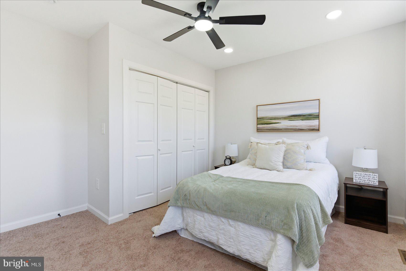 2009 Ruxton Avenue Baltimore, MD 21216 - Photo 20 of 37 a bedroom with a bed and a chandelier