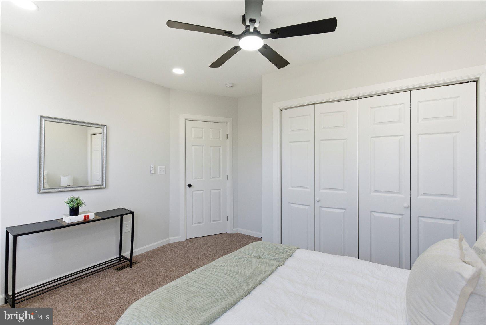2009 Ruxton Avenue Baltimore, MD 21216 - Photo 21 of 37 a bedroom with a bed and a chandelier
