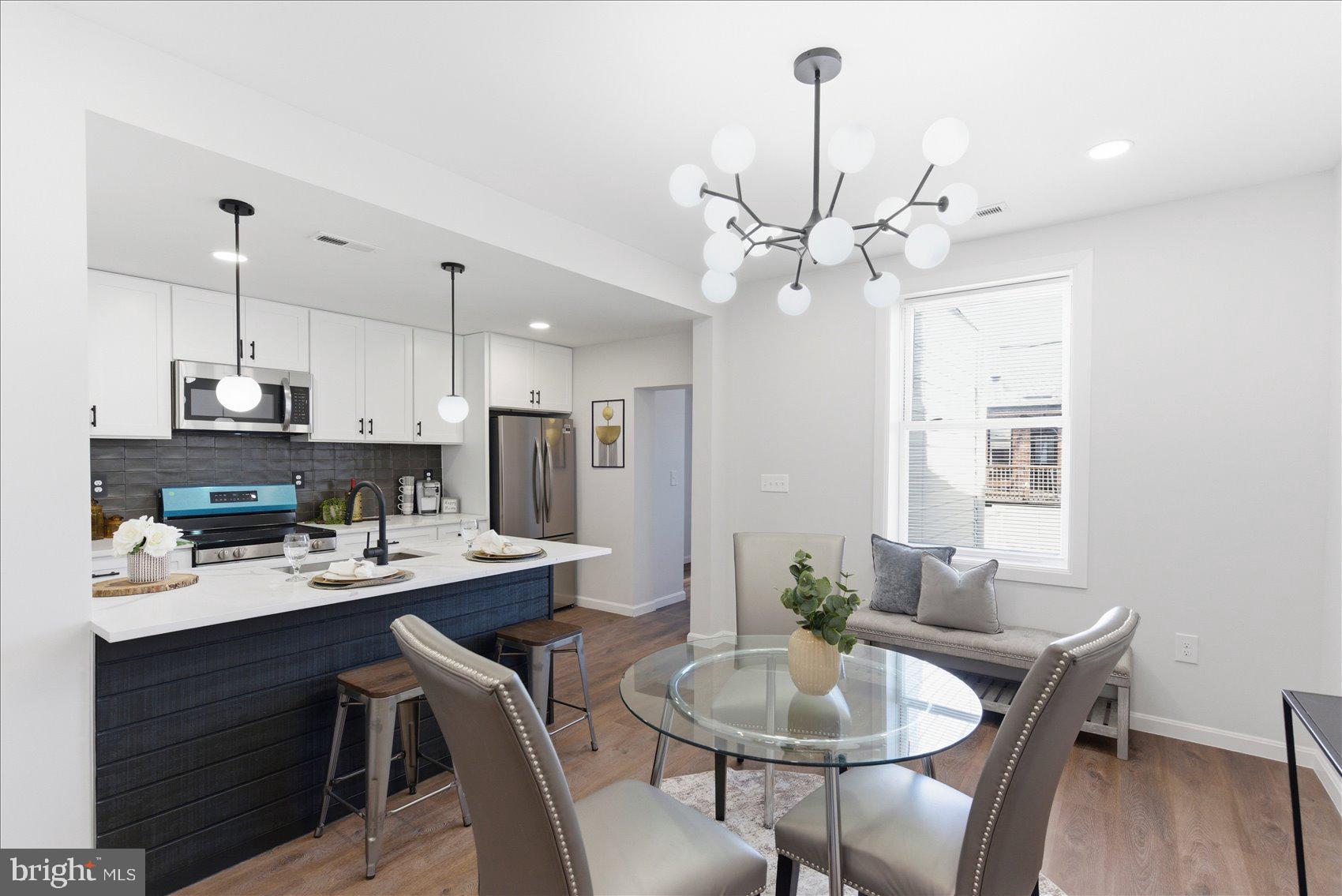 2009 Ruxton Avenue Baltimore, MD 21216 - Photo 6 of 37 a dining room with furniture a chandelier and wooden floor