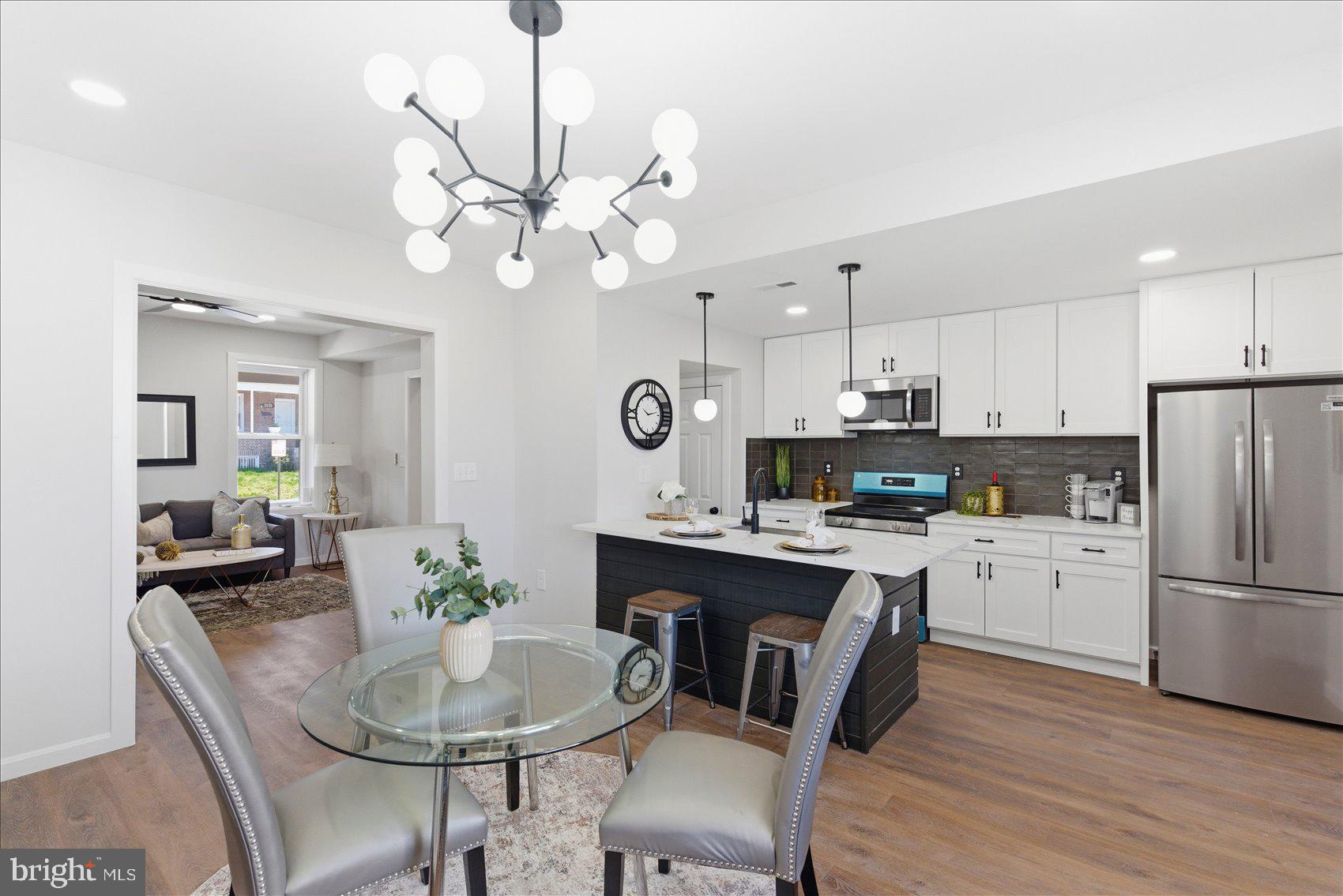 2009 Ruxton Avenue Baltimore, MD 21216 - Photo 7 of 37 a kitchen with a dining table cabinets appliances and wooden floor