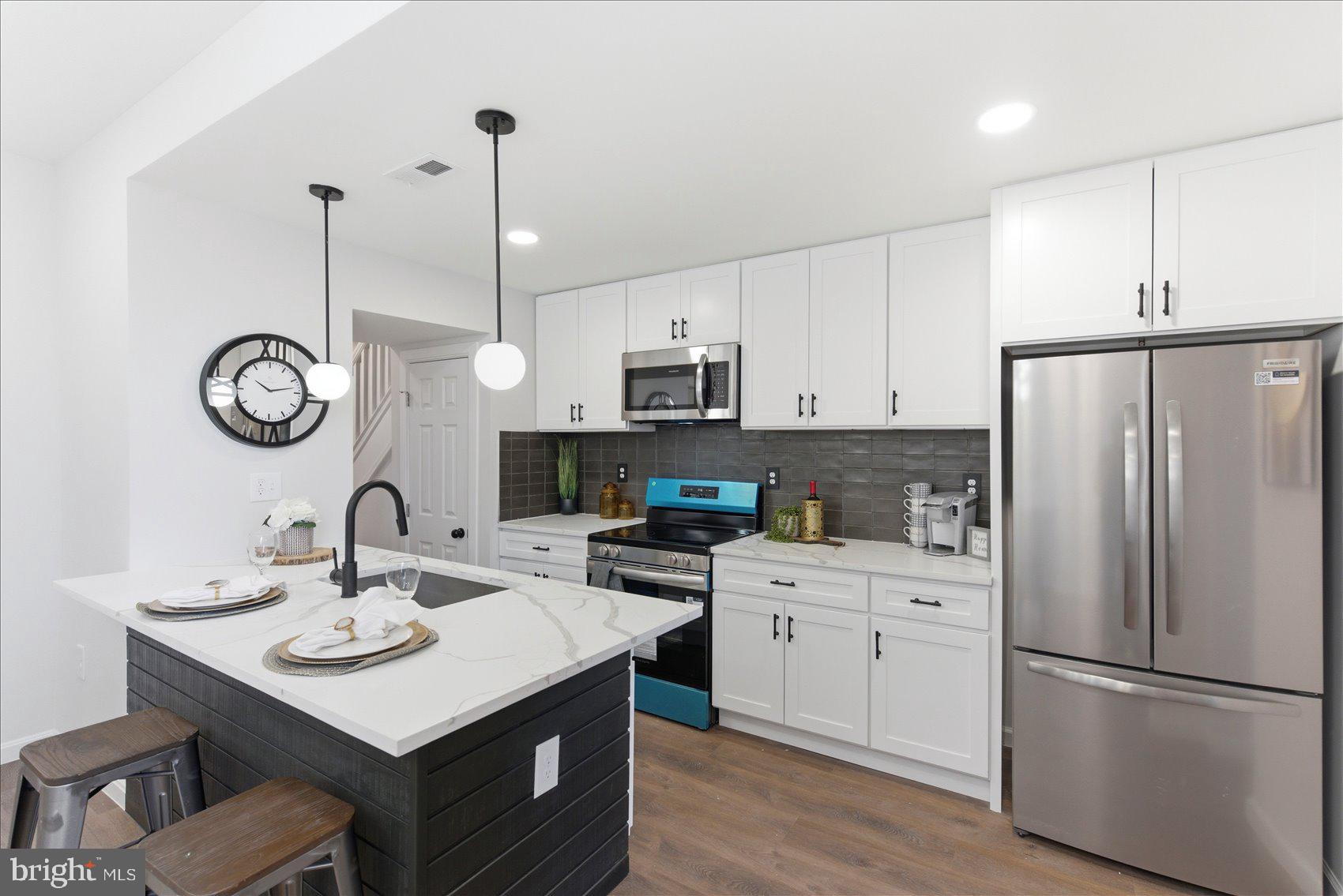 2009 Ruxton Avenue Baltimore, MD 21216 - Photo 8 of 37 a kitchen with a sink a microwave a stove and refrigerator
