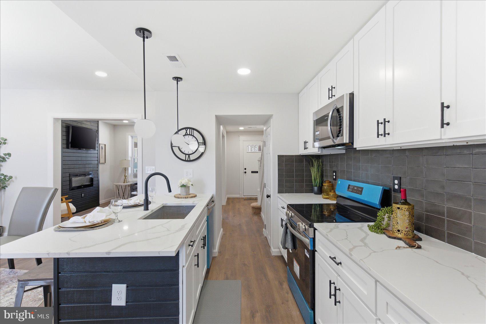 2009 Ruxton Avenue Baltimore, MD 21216 - Photo 10 of 37 a kitchen with stainless steel appliances granite countertop a sink a stove and cabinets