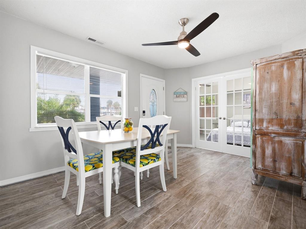 1207 1st Street Indian Rocks Beach, FL 33785 - Photo 7 of 60 a view of a dining room with furniture window and wooden floor