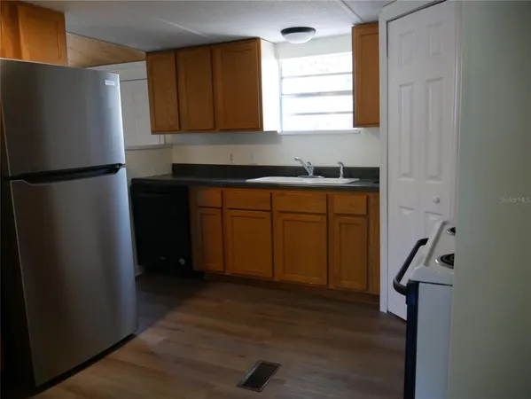 a kitchen with a refrigerator and window