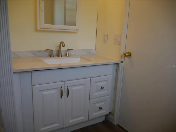 a bathroom with a sink and mirror