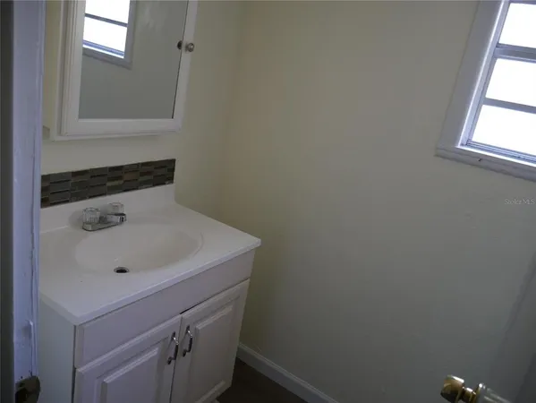 a bathroom with a sink and vanity