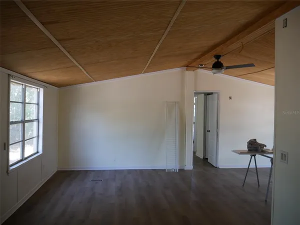 a view of a livingroom with wooden floor and a window