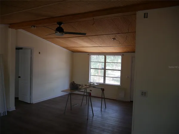 a workspace with wooden floor and a window