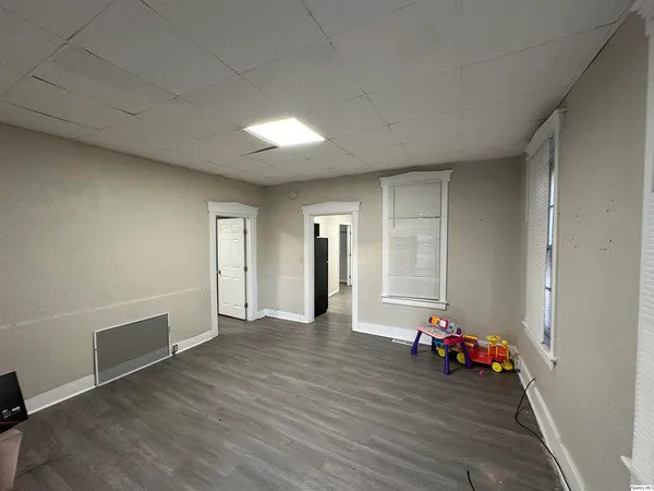 a view of a room with wooden floor and stairs