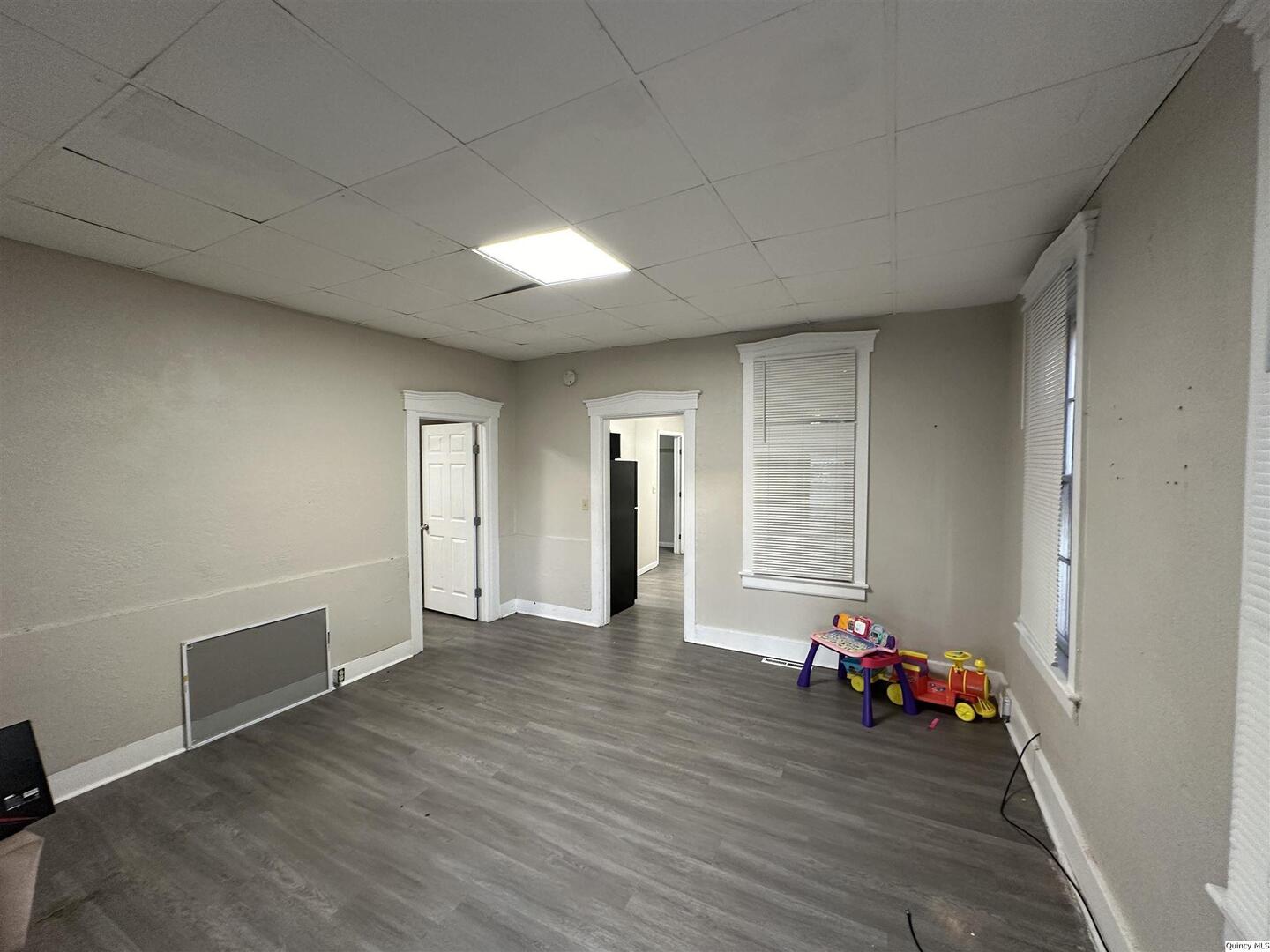 812 North 7th Street Quincy, IL 62301 - Photo 3 of 18 a view of a room with wooden floor and stairs