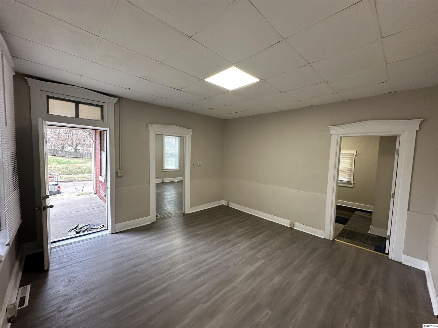 812 North 7th Street Quincy, IL 62301 - Photo 6 of 18 an empty room with wooden floor and windows