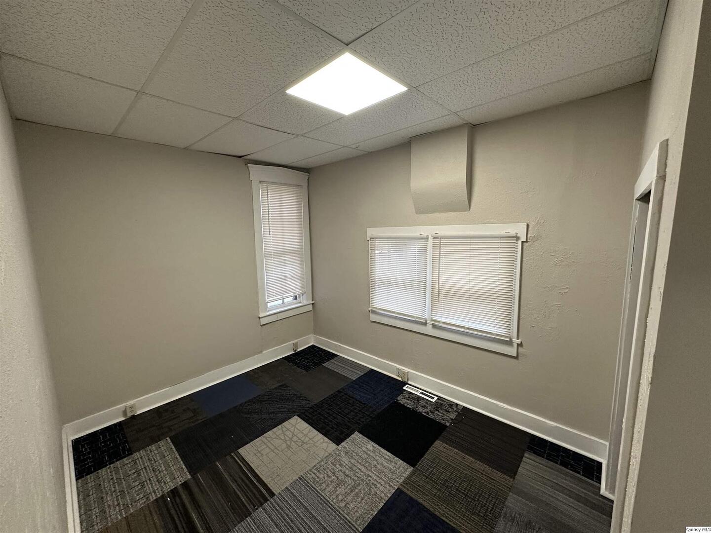 812 North 7th Street Quincy, IL 62301 - Photo 9 of 18 an empty room with windows and wooden floor