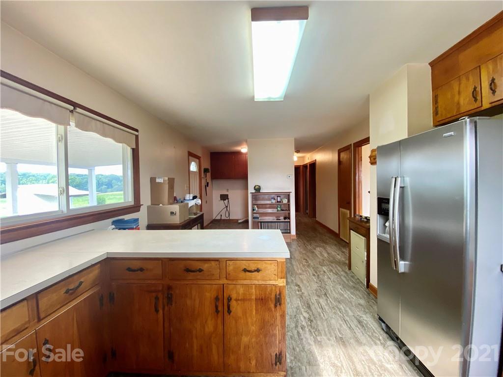 127 Countryside Road Harmony, NC 28634 - Photo 11 of 27 a kitchen with kitchen island a counter top space a sink and stainless steel appliances