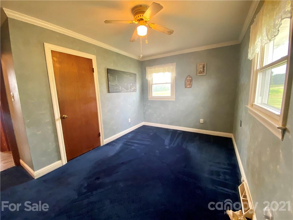 127 Countryside Road Harmony, NC 28634 - Photo 12 of 27 an empty room with windows and fan