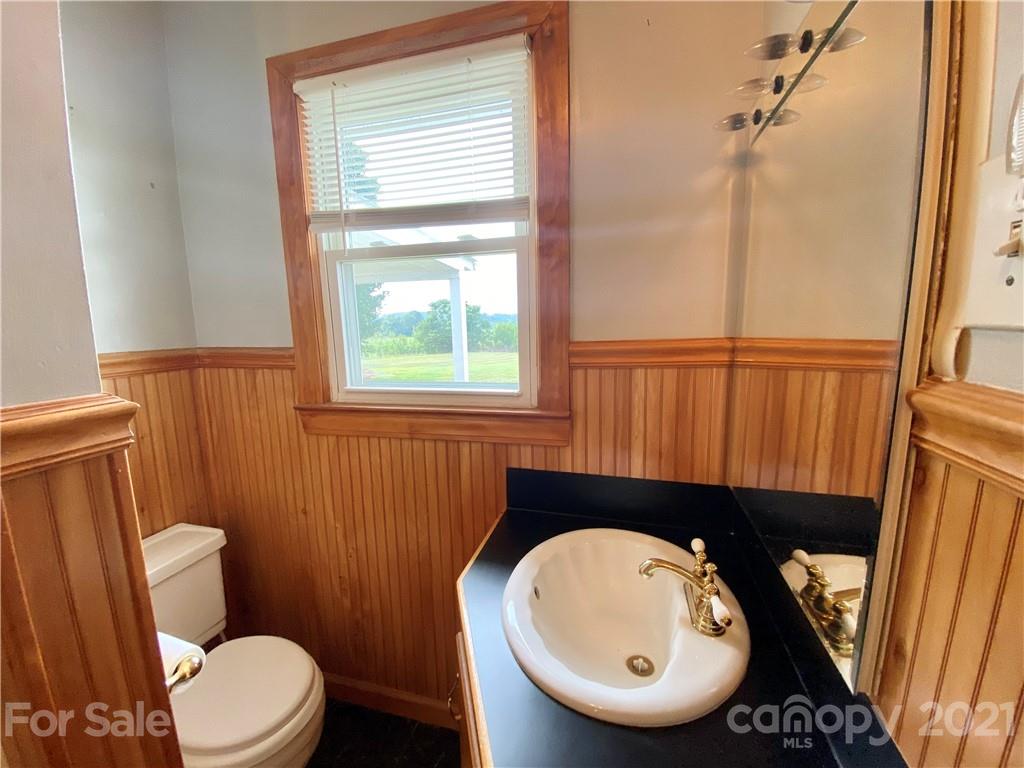 127 Countryside Road Harmony, NC 28634 - Photo 15 of 27 a bathroom with a toilet a sink and a mirror