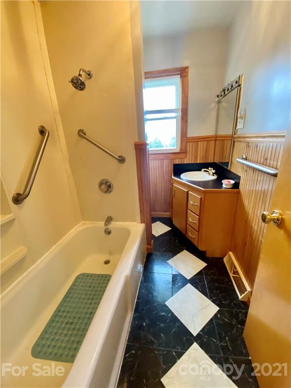 127 Countryside Road Harmony, NC 28634 - Photo 16 of 27 a bathroom with a tub sink and mirror