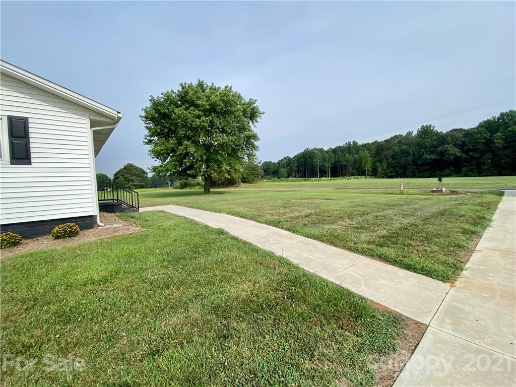 127 Countryside Road Harmony, NC 28634 - Photo 21 of 27 a view of a field of grass and trees