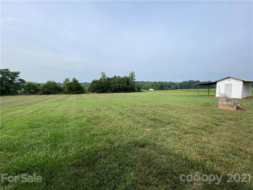 127 Countryside Road Harmony, NC 28634 - Photo 25 of 27 a view of a field with an trees in the background