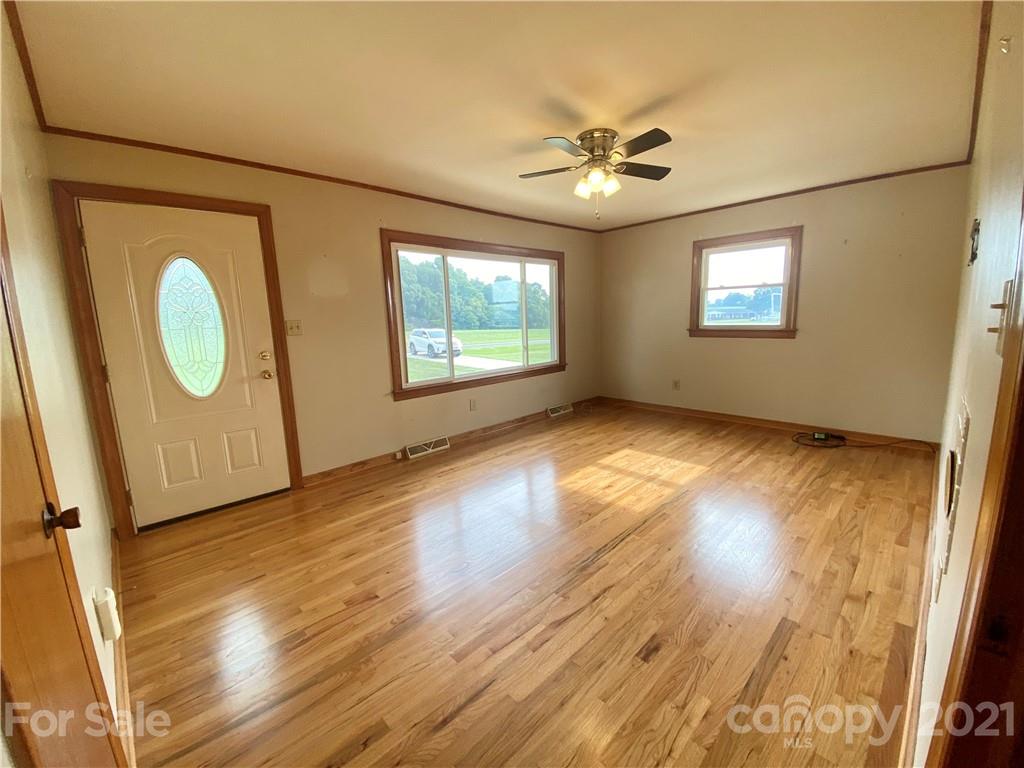 127 Countryside Road Harmony, NC 28634 - Photo 7 of 27 a view of empty room with wooden floor and fan