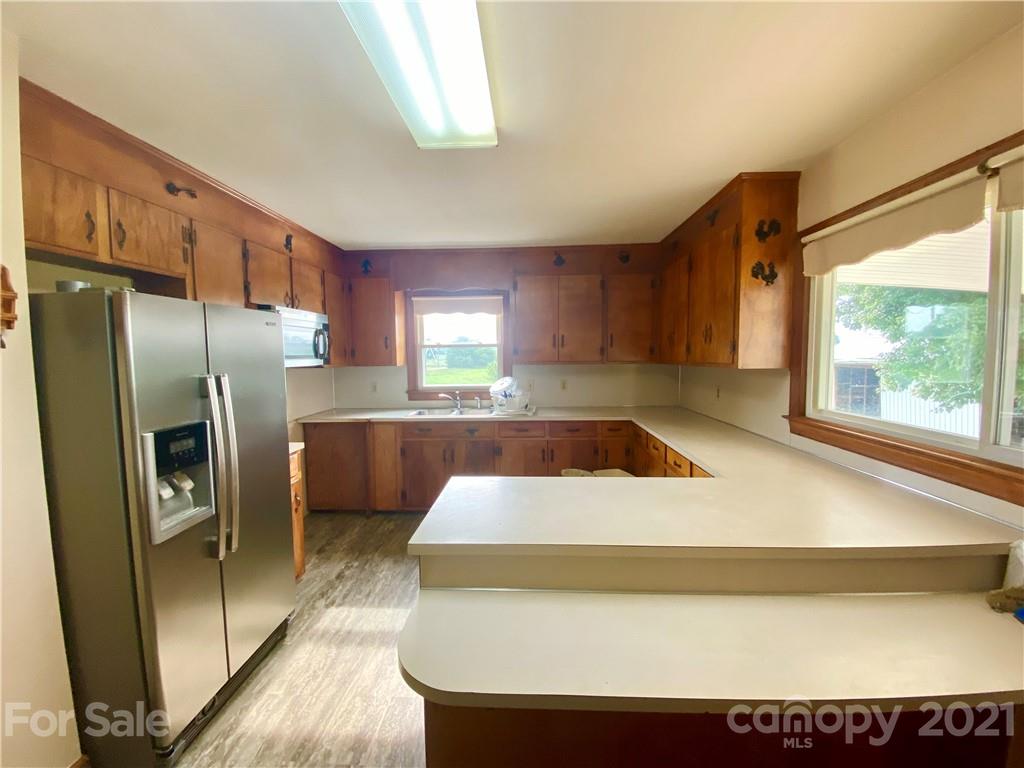127 Countryside Road Harmony, NC 28634 - Photo 8 of 27 a kitchen with a refrigerator a sink and a window