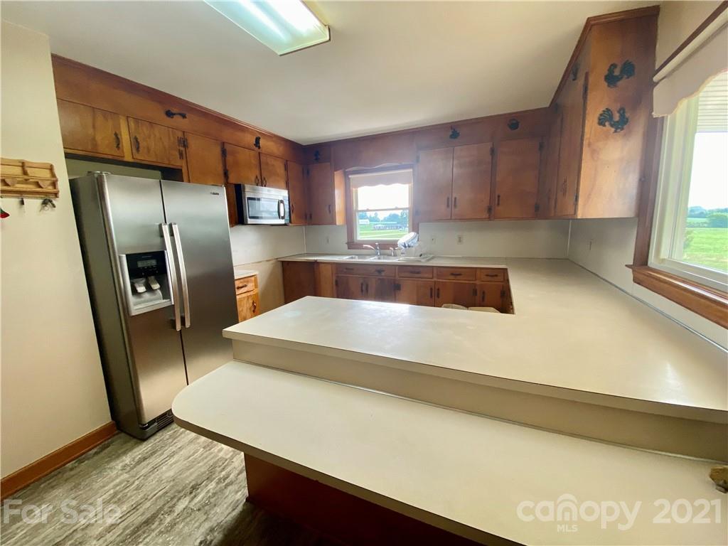 127 Countryside Road Harmony, NC 28634 - Photo 10 of 27 a kitchen with stainless steel appliances a refrigerator and a sink