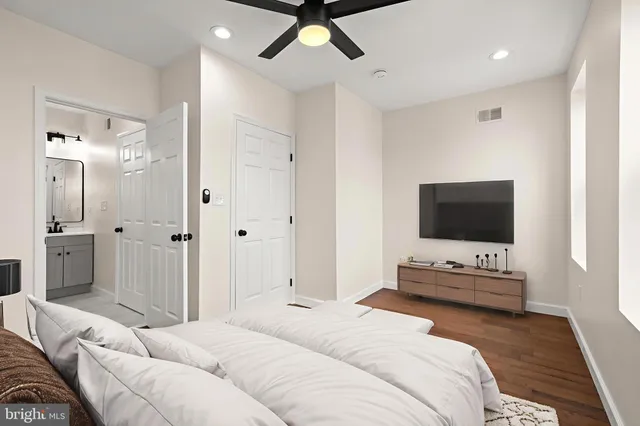 a bedroom with a bed and a flat screen tv