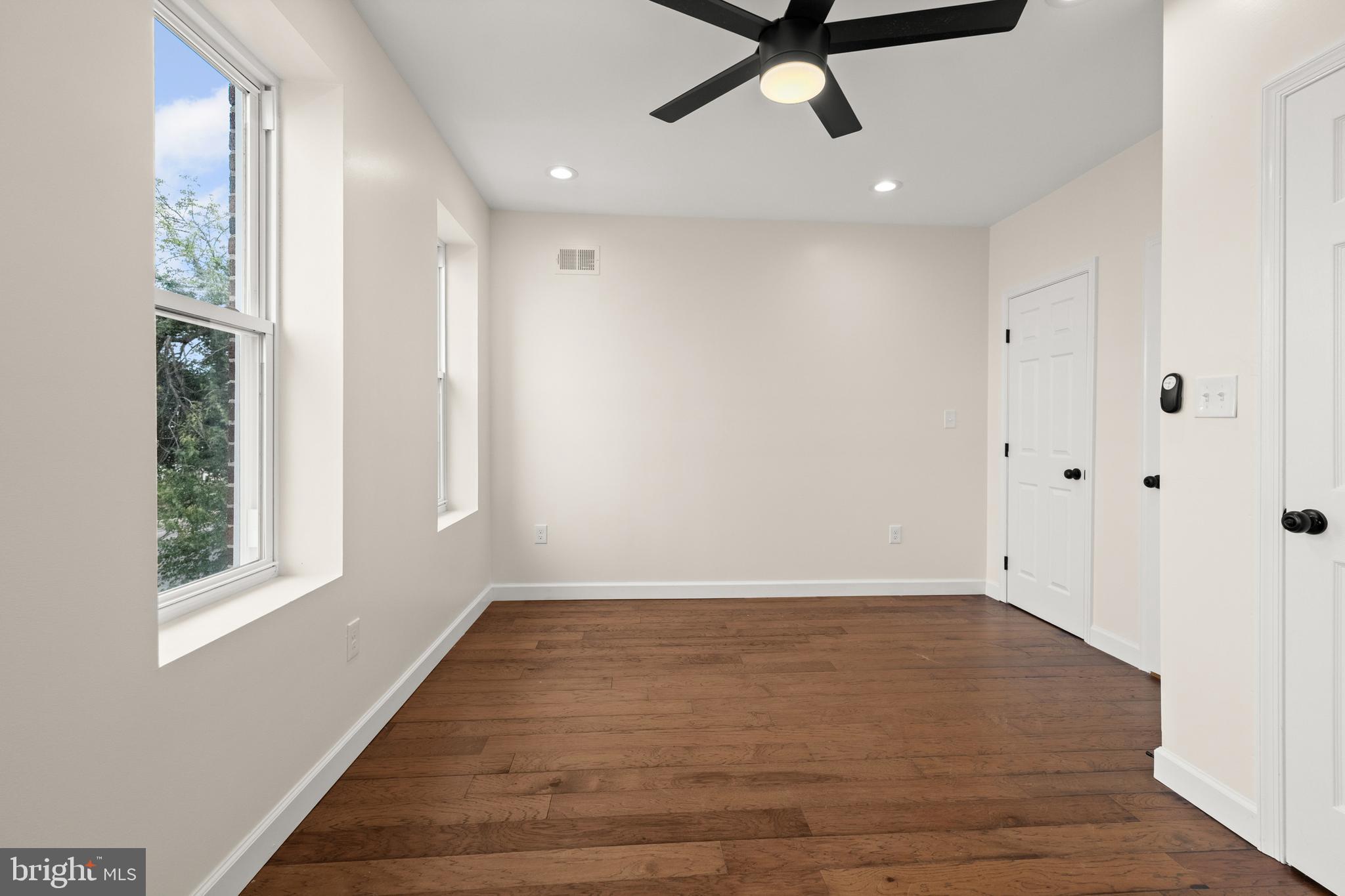 2815 West Cold Spring Lane Baltimore, MD 21215 - Photo 12 of 37 wooden floor in an empty room with a window