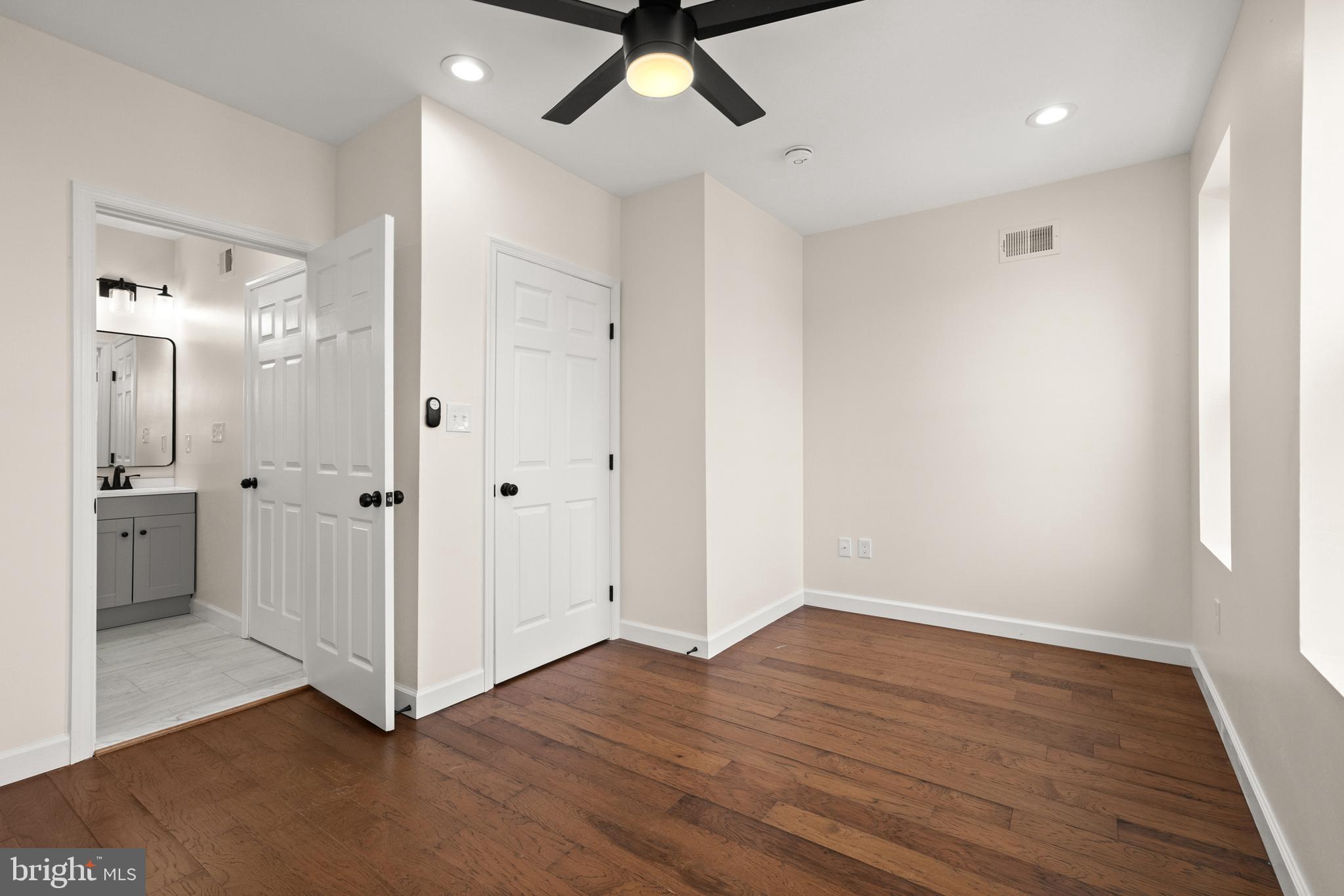 2815 West Cold Spring Lane Baltimore, MD 21215 - Photo 13 of 37 an empty room with wooden floor and mirror