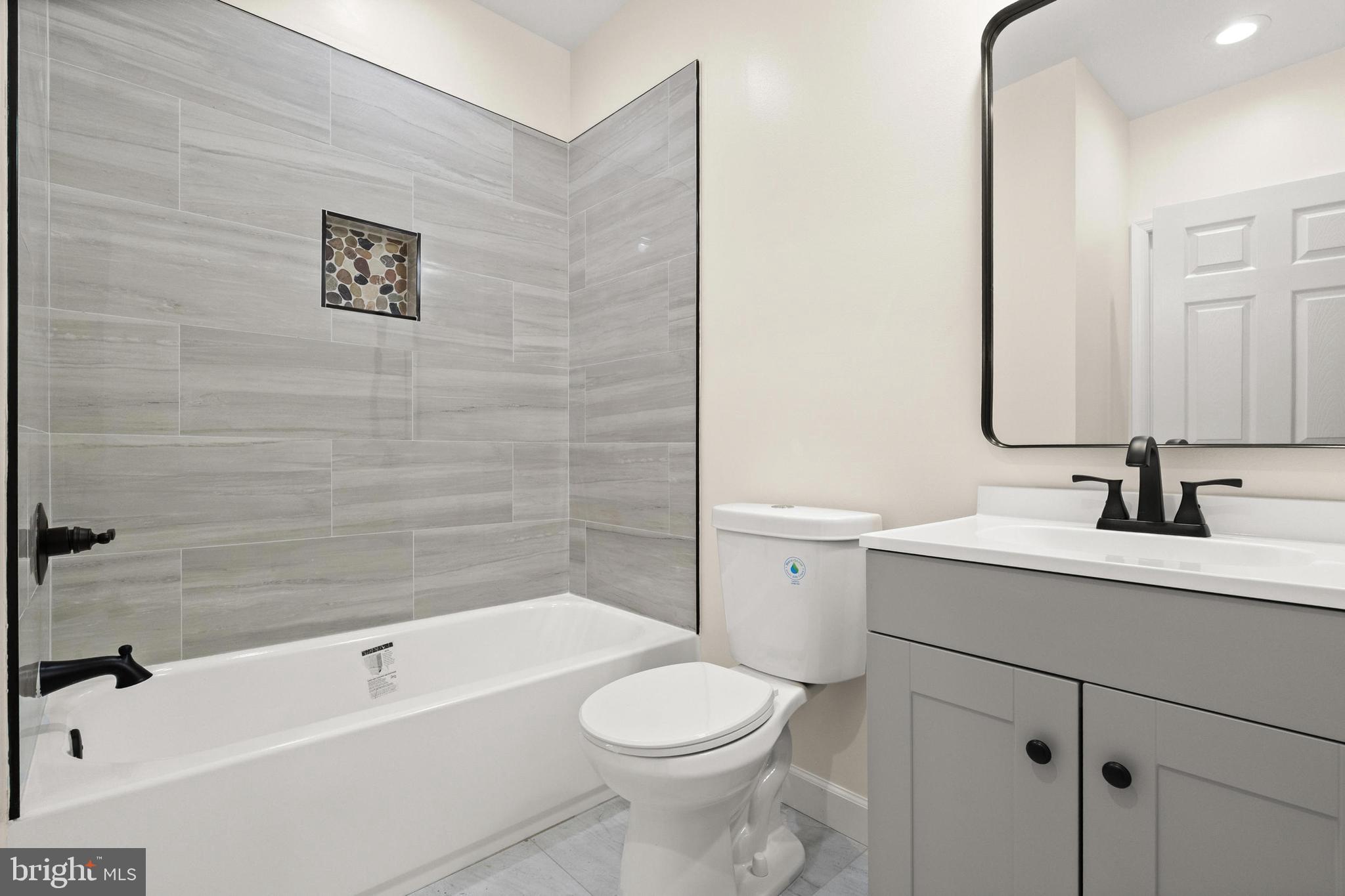 2815 West Cold Spring Lane Baltimore, MD 21215 - Photo 14 of 37 a bathroom with a sink a toilet and shower