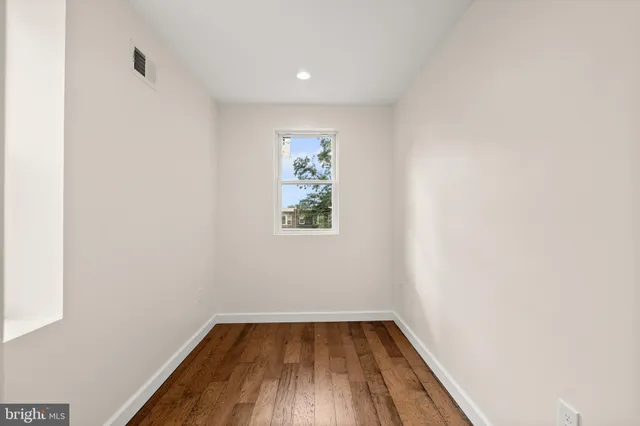 a view of a room with wooden floor and window