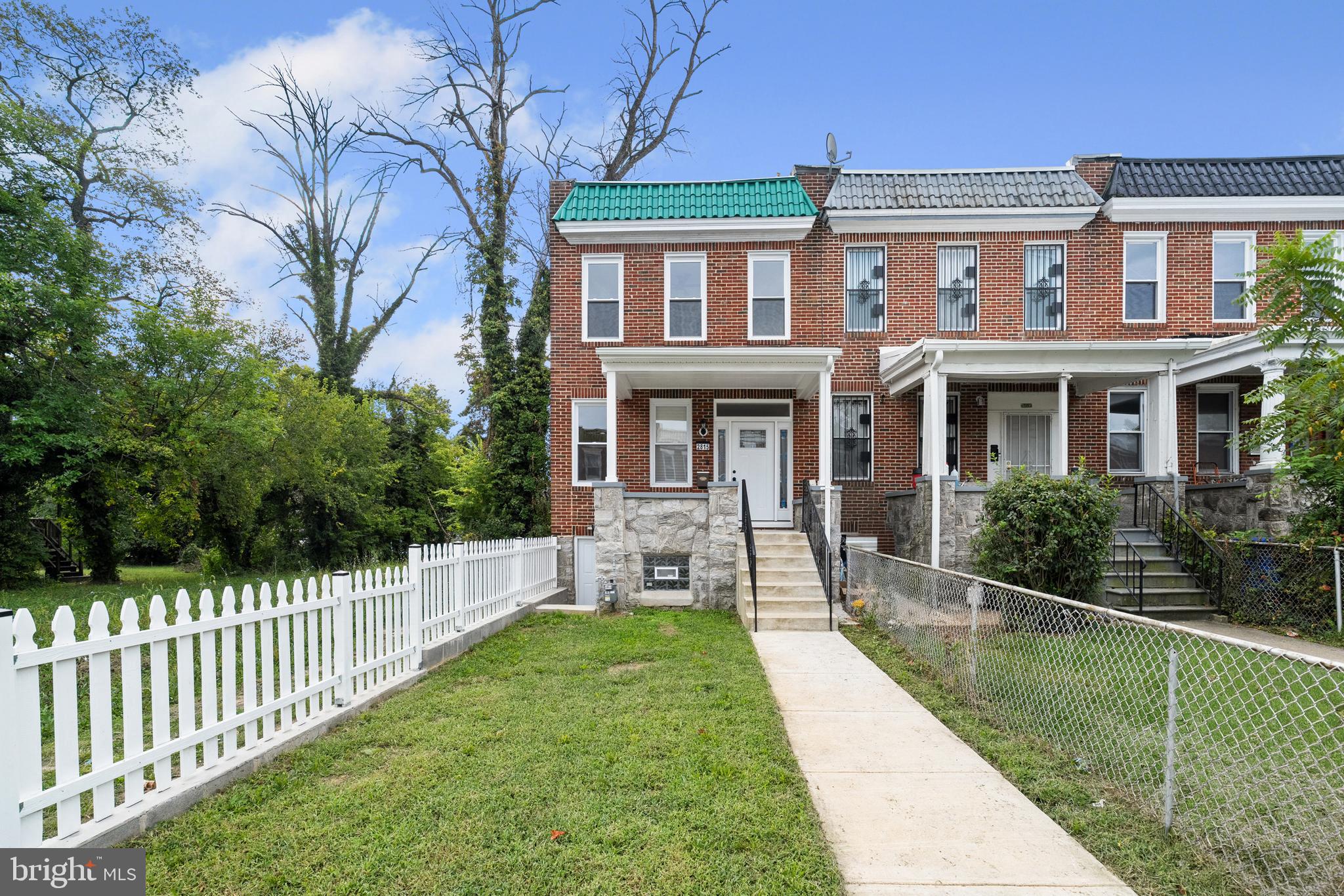 2815 West Cold Spring Lane Baltimore, MD 21215 - Photo 2 of 37 a front view of a house with a yard