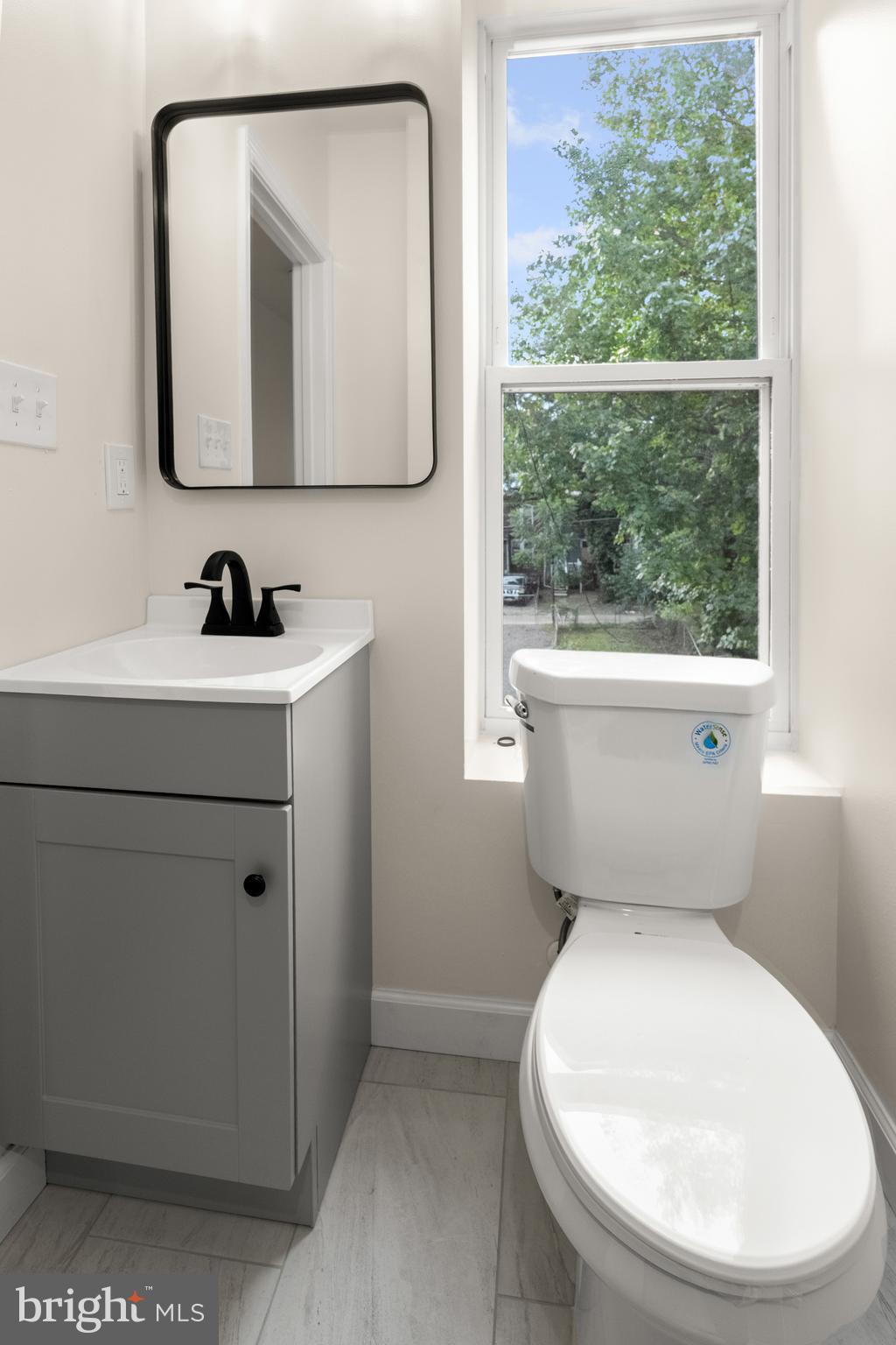 2815 West Cold Spring Lane Baltimore, MD 21215 - Photo 21 of 37 a bathroom with a toilet a sink and a mirror