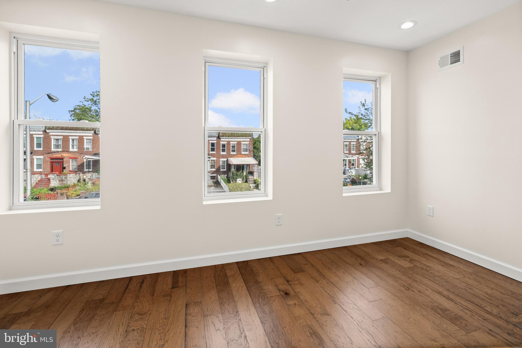 2815 West Cold Spring Lane Baltimore, MD 21215 - Photo 24 of 37 a view of an empty room with wooden floor and a window