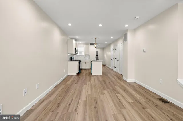 a view of kitchen with wooden floor and electronic appliances