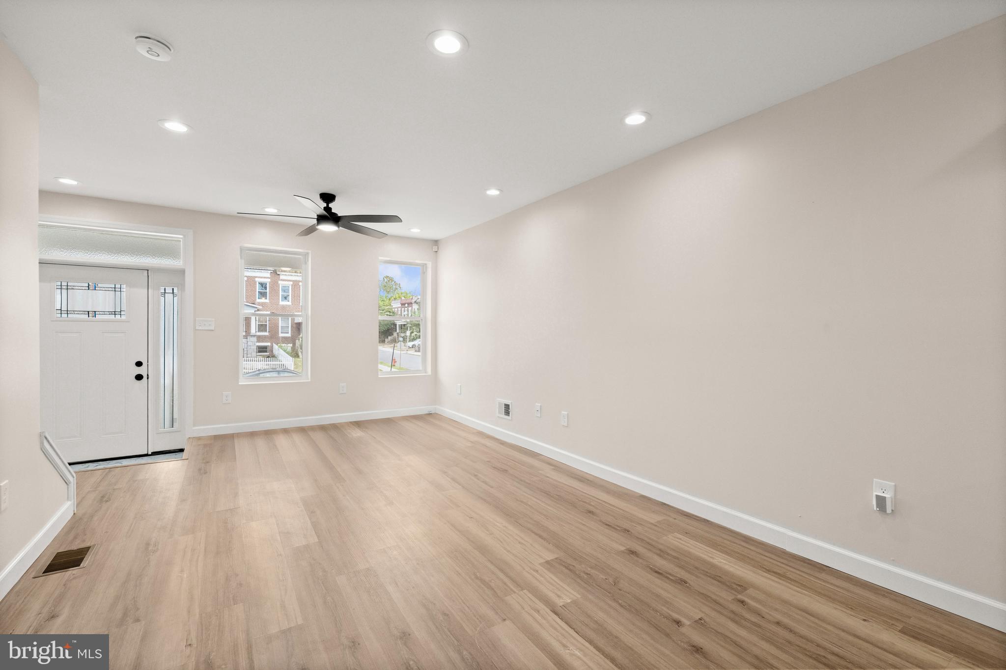2815 West Cold Spring Lane Baltimore, MD 21215 - Photo 7 of 37 an empty room with wooden floor and windows