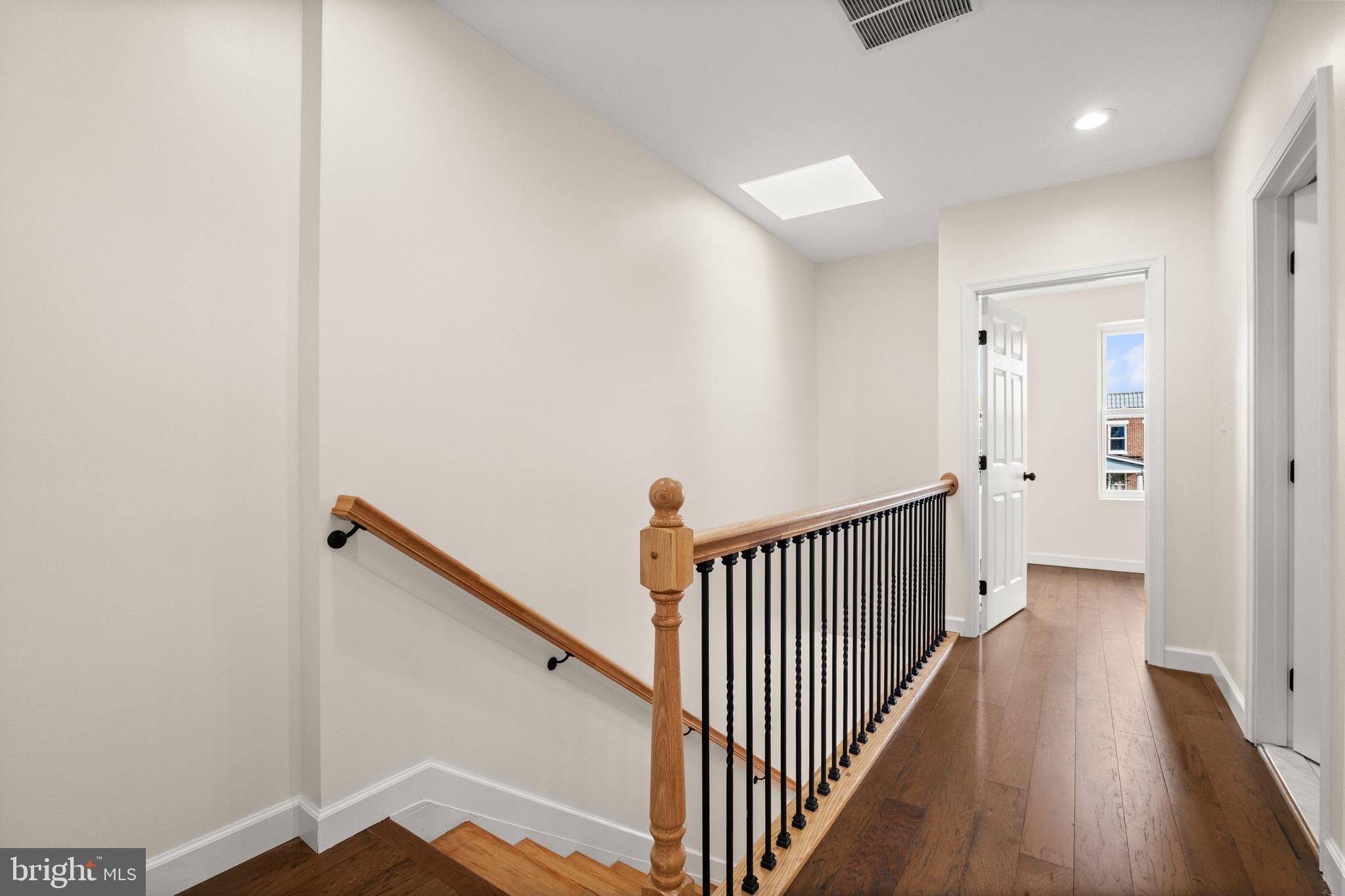 2815 West Cold Spring Lane Baltimore, MD 21215 - Photo 10 of 37 a view of a hallway with wooden floor and staircase