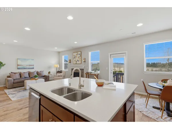 a kitchen with a sink a table and chairs
