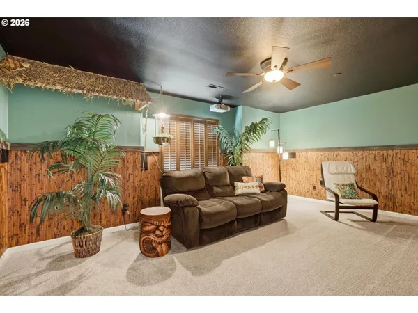 a living room with furniture and a potted plant