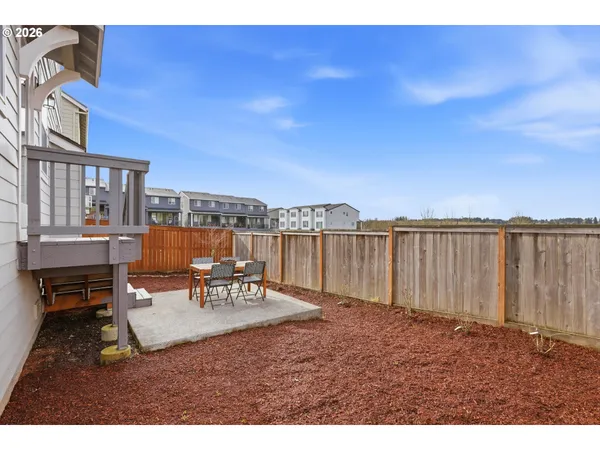 a view of a patio with a table and chairs