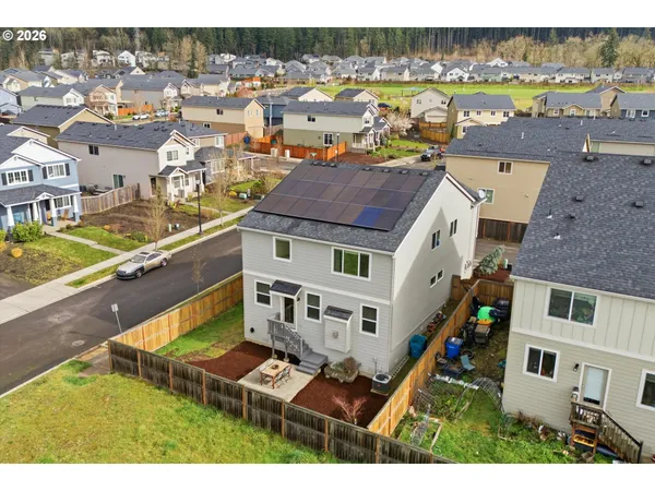 an aerial view of residential houses with outdoor space