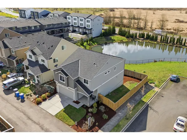 an aerial view of a house with a yard and lake view