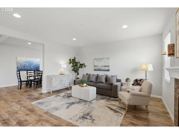 a living room with furniture and a dining area